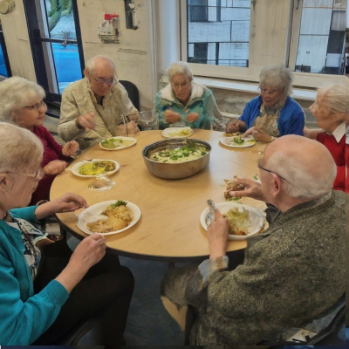 an AI generated image showing older people enjoying a meal together 