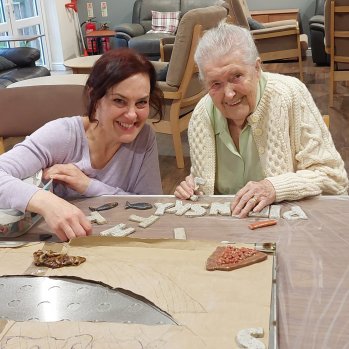 Two women creating a ceramic sign for the new Pie in the Sky cafe