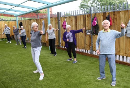 Group of older people dancing outside 