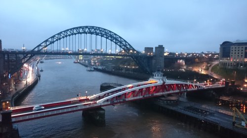 Picture of the Swing and Tyne Bridges on a cloudy day, from the Gateshead side.
