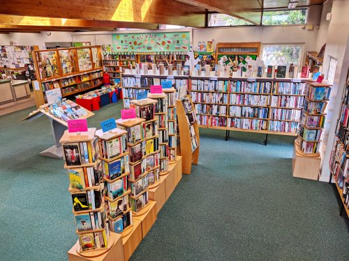 photo of the inside of the library showing many full book cases 