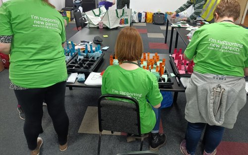 Volunteers with their back to the camera