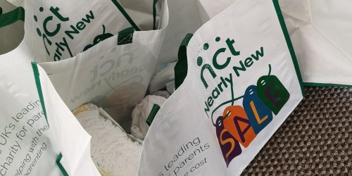 Parents pushing children in buggies while walking