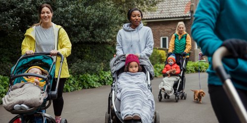 volunteers walking with children in pushchairs