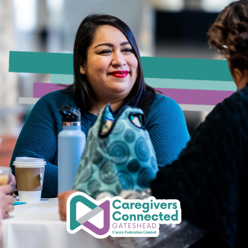 Activity volunteer enjoying a catch up with caregivers.