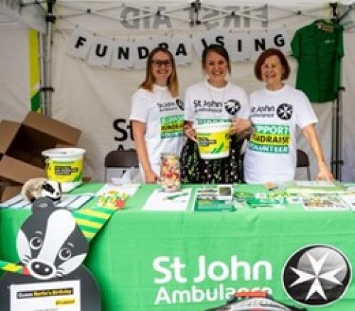 3 St John volunteers at a stall