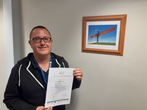 Paul holding his certificate