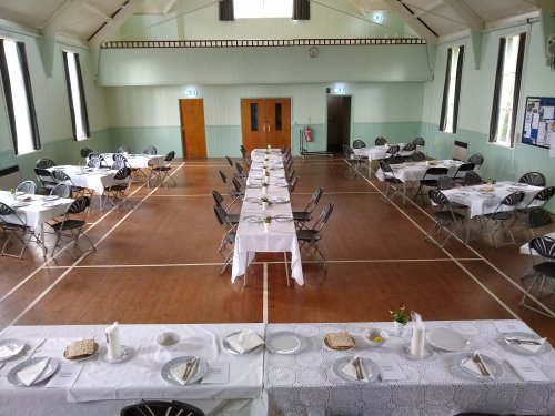 hall laid out with tables for a celebration