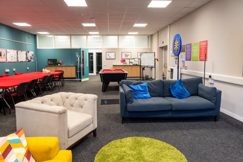 The Stonewall Room featuring sofas, pool table, and community drop-in chairs and tables