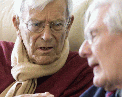 2 older men having a conversation.