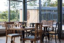 Cafe with wooden furniture and big windows