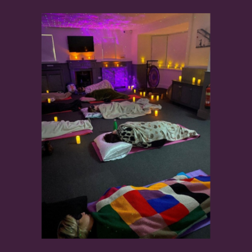 Image of people lying down with eye masks, meditating
