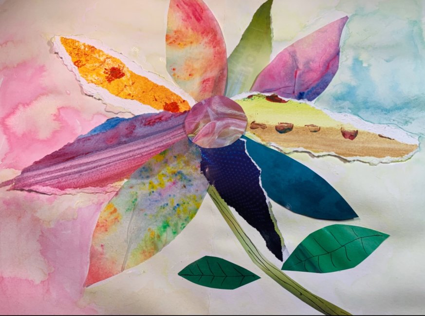 A picture of a flower, made of different coloured collaged paper with a colourful background.