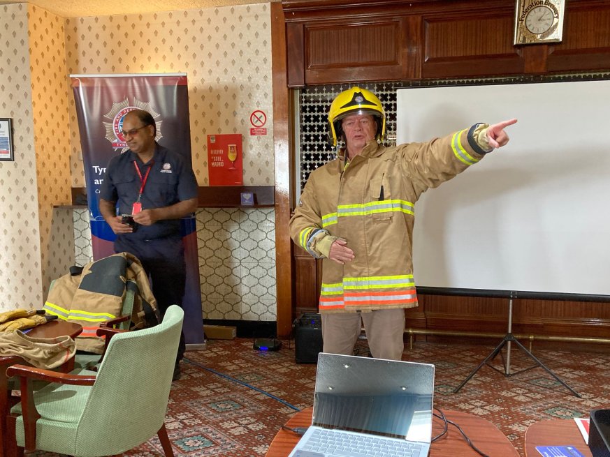 Photograph of a fireman delivering a presentation