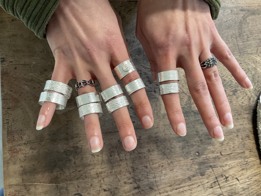 Silver rings displayed on fingers