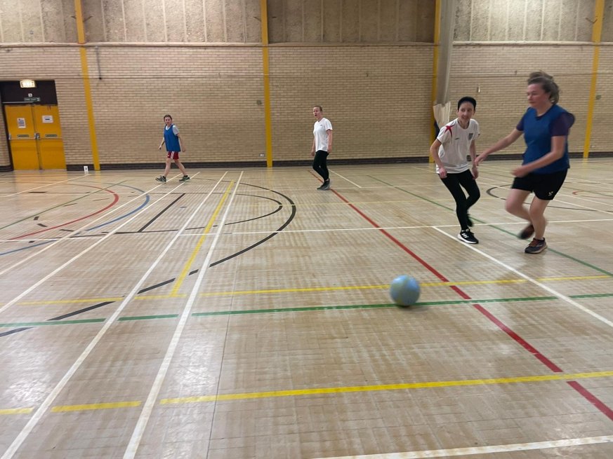 a women about to kick a football. 