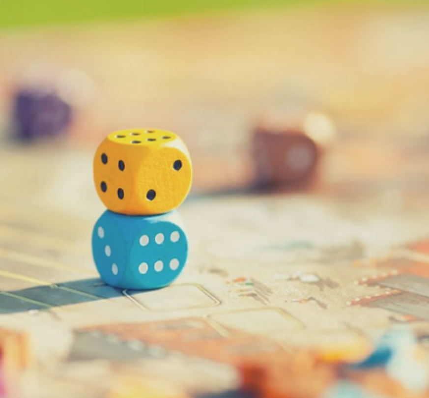 Two dice stacked onto each other on a table.