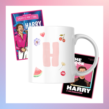 A mug with a pink H decorated with fruit and flowers. Behind the mug are two Harry Styles biographies.