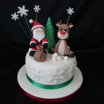 Santa and Rudloph on top of a Christmas Cake