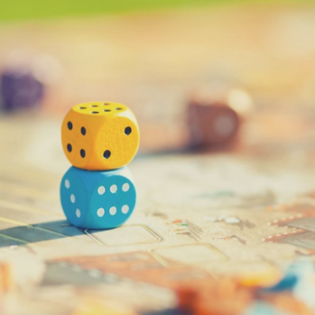 Two dice stacked onto each other on a table.