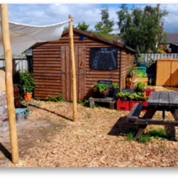 Wooden shed and picnic table in the garden
