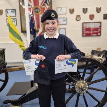 Junior Cadet with certificates and badges