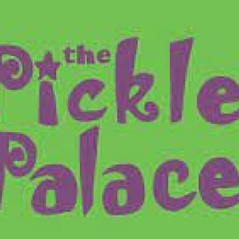 Green background with The Pickle Palace written in purple and flanked by a purple castle on either side.