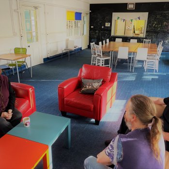 Staff seated on sofas in Parker Hall