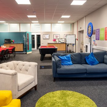 The Stonewall Room featuring sofas, pool table, and community drop-in chairs and tables