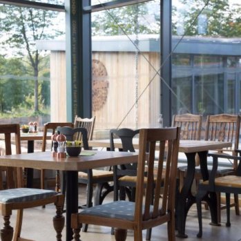 Cafe with wooden furniture and big windows