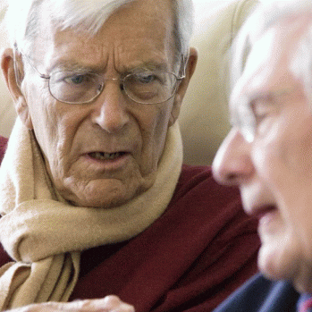 2 older men having a conversation.
